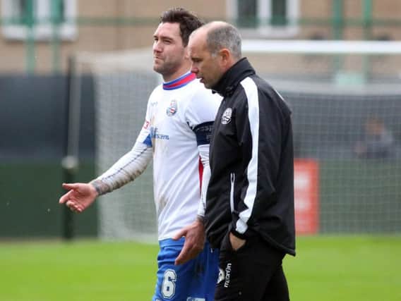 Andy Peaks and midfielder Richard Bunting talk things over following AFC Rushden & Diamonds' FA Trophy loss to Kidsgrove Athletic at the weekend. Pictures by Alison Bagley