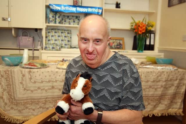 Birthday Celebration: Kettering: Robin SMith, who was born with Down Syndrome, celebrating his 76th birthday with friends and carers at his home in Kettering. Monday October 9th 2017 NNL-170910-205429009