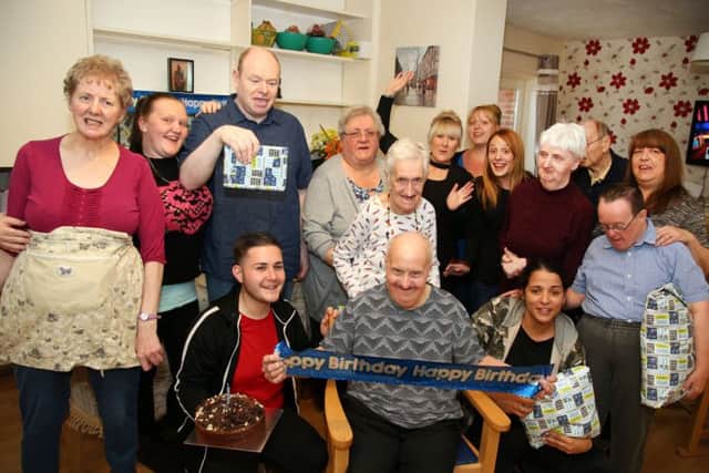 Birthday Celebration: Kettering: Robin SMith, who was born with Down Syndrome, celebrating his 76th birthday with friends and carers at his home in Kettering. Monday October 9th 2017 NNL-170910-205403009