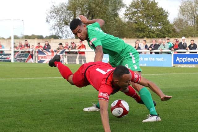 Kettering's Rhys Hoenes goes down under a challenge from Nantwich's Courtney Wildin during Saturday's 1-1 draw. The two teams meet again in the FA Cup fourth qualifying round replay at Latimer Park tonight with Stevenage awaiting the winners. Picture by Peter Short