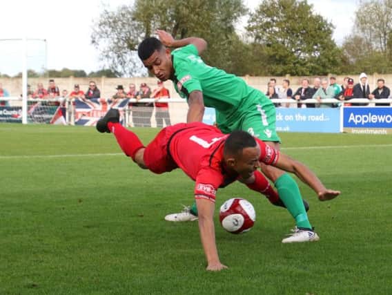 Kettering's Rhys Hoenes goes down under a challenge from Nantwich's Courtney Wildin during Saturday's 1-1 draw. The two teams meet again in the FA Cup fourth qualifying round replay at Latimer Park tonight with Stevenage awaiting the winners. Picture by Peter Short