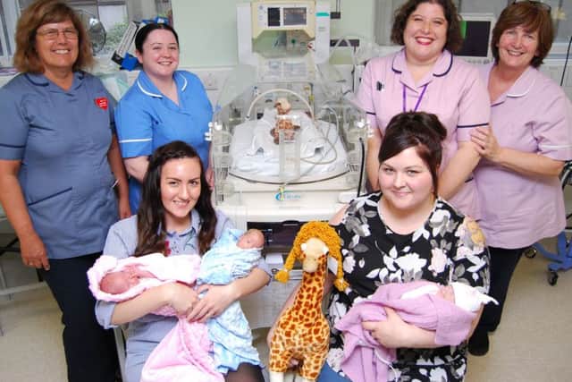 From left, matron Jeannette Payne, staff nurse Hannah Smith, Rachel Messer and her twins Indiana and Jetson, senior administrator Sara Hales, healthcare assistant Sue Harman, Stephanie Burlington and her daughter Gracie pictured with a giraffe style incubator and the appeals mascot George the Giraffe