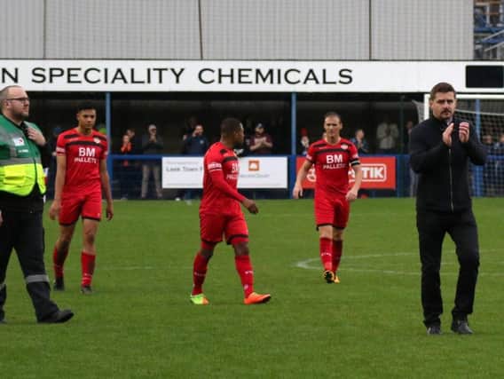 Kettering Town boss Marcus Law applauds the travelling fans following his side's FA Trophy exit at Leek Town on Saturday. Pictures by Peter Short