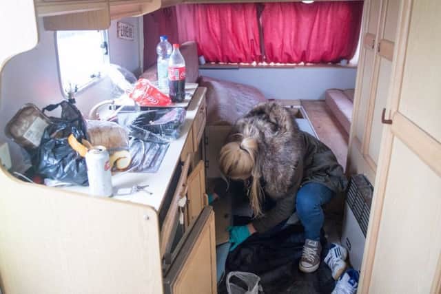 An officer searching one of the caravans