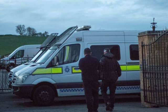 Officers during one of yesterday's raids