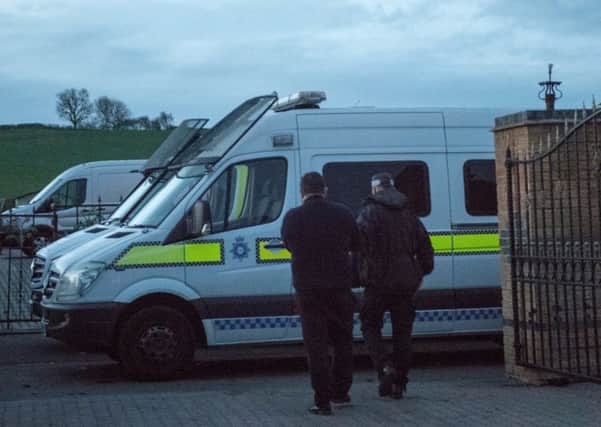 Officers during one of yesterday's raids