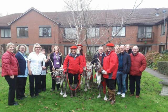 Staff and relatives of patients at Cransley Hospice with the reindeer.
