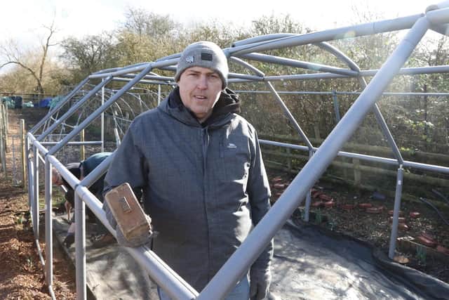 Andy Murray with the frame of the polytunnel